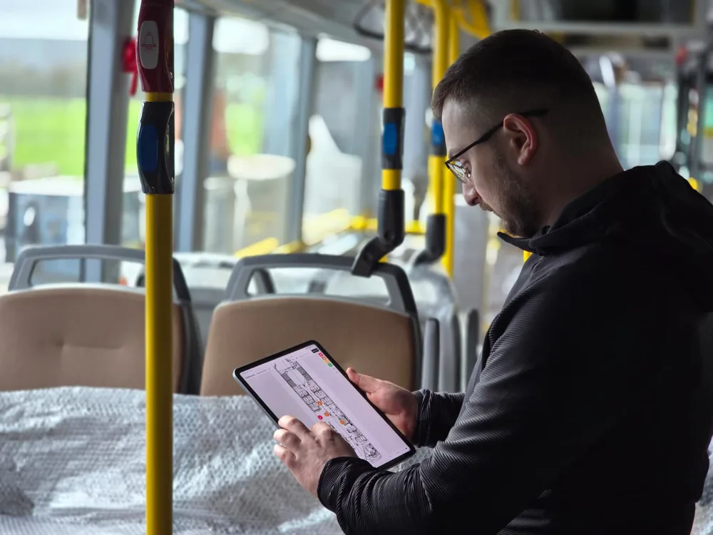 Inspektor rejestruje usterki na tablecie w autobusie